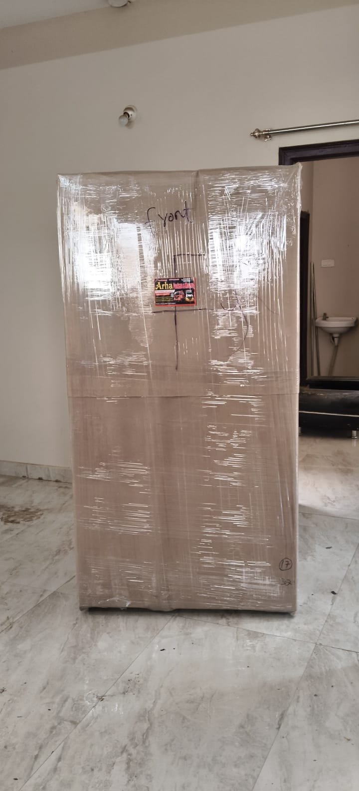 Tall carton wrapped with ARHA Packers and Movers label