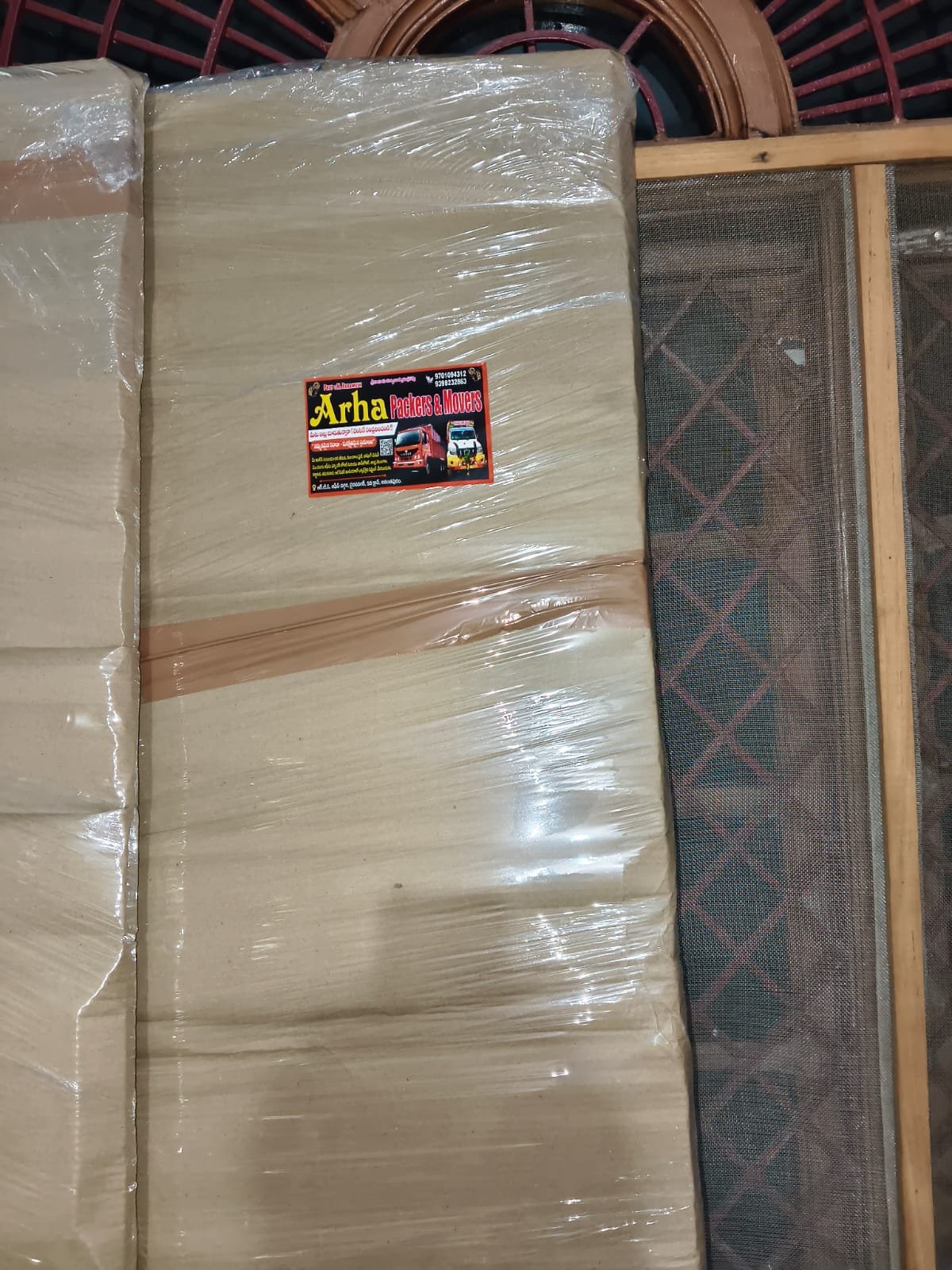 Close view of a wrapped item with ARHA Packers and Movers label