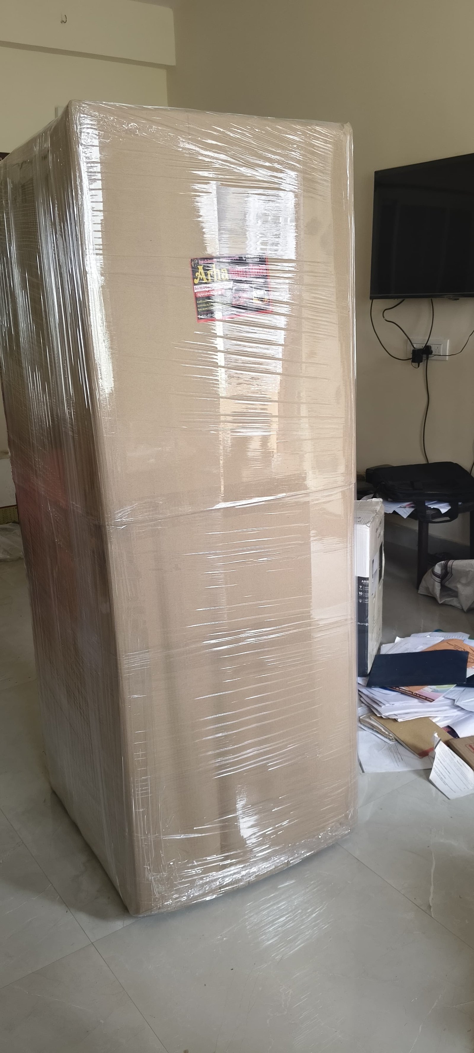 Large wrapped furniture item inside a room