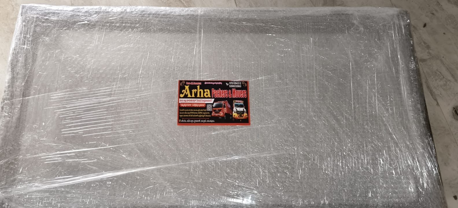 Bubble-wrapped item with ARHA Packers and Movers label