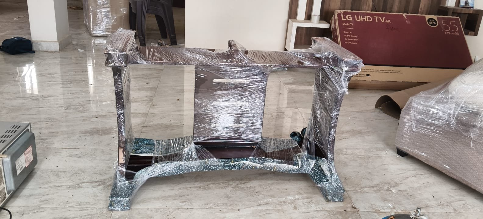 Packed furniture pieces in covered parking area