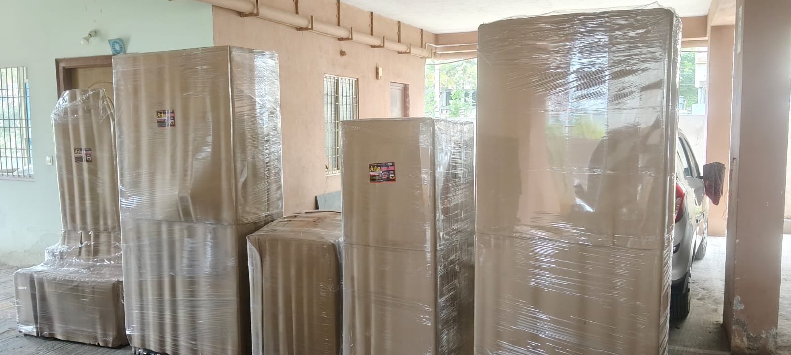 Wrapped carton or appliance standing indoors
